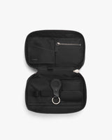 Open travel organizer with zipper compartments and a key ring.