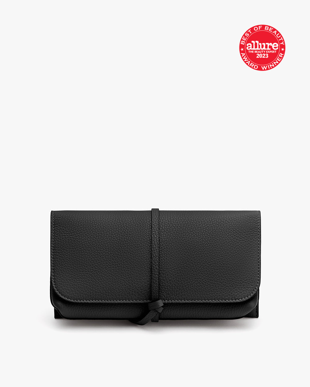 Travel Beauty Roll A folded wallet with a strap and a seal in the top right corner.