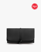 A folded wallet with a strap and a seal in the top right corner.