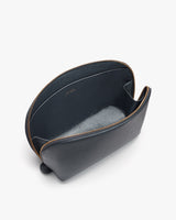 Open leather bag with zipper on white background.