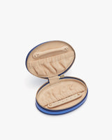 Open small round case with interior pockets and zipper closure.