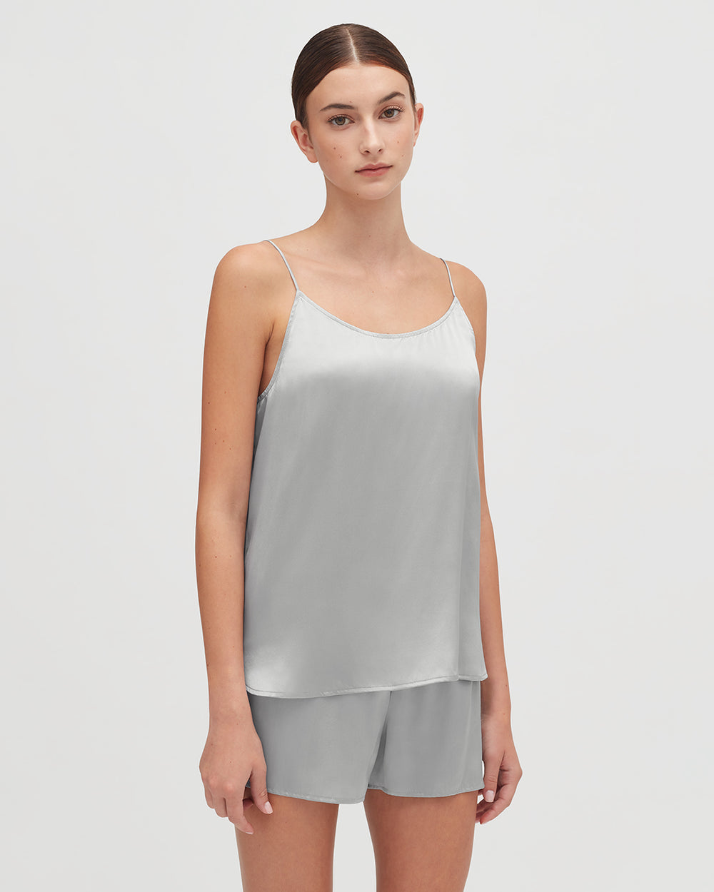 Washable Charmeuse Cross-Back Cami Woman standing in sleeveless top and shorts against a white background.