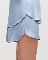 Close-up of a person wearing a layered skirt.