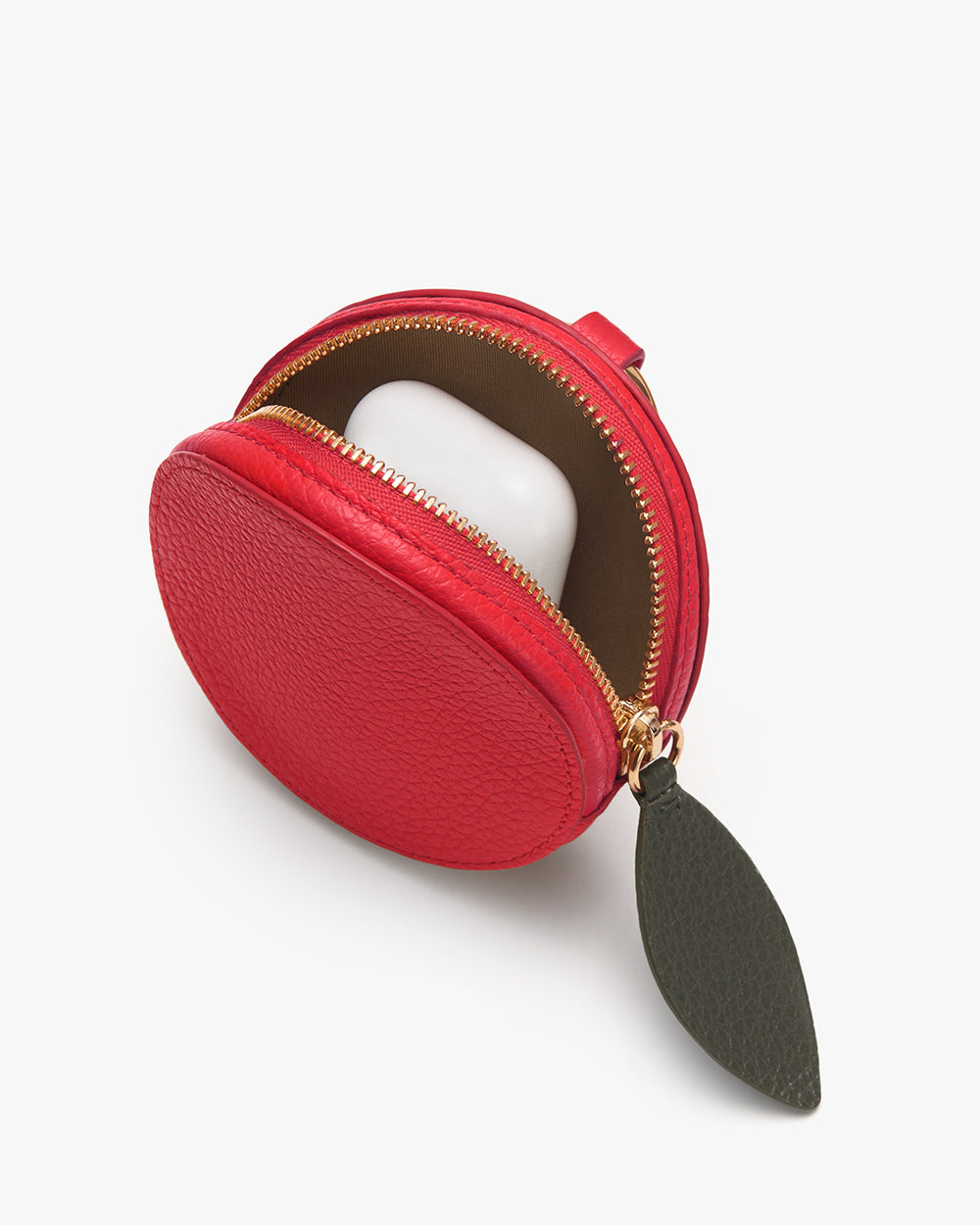 Cherry Pouch Round pouch with zipper and leaf-shaped pull tab, containing a small white case.