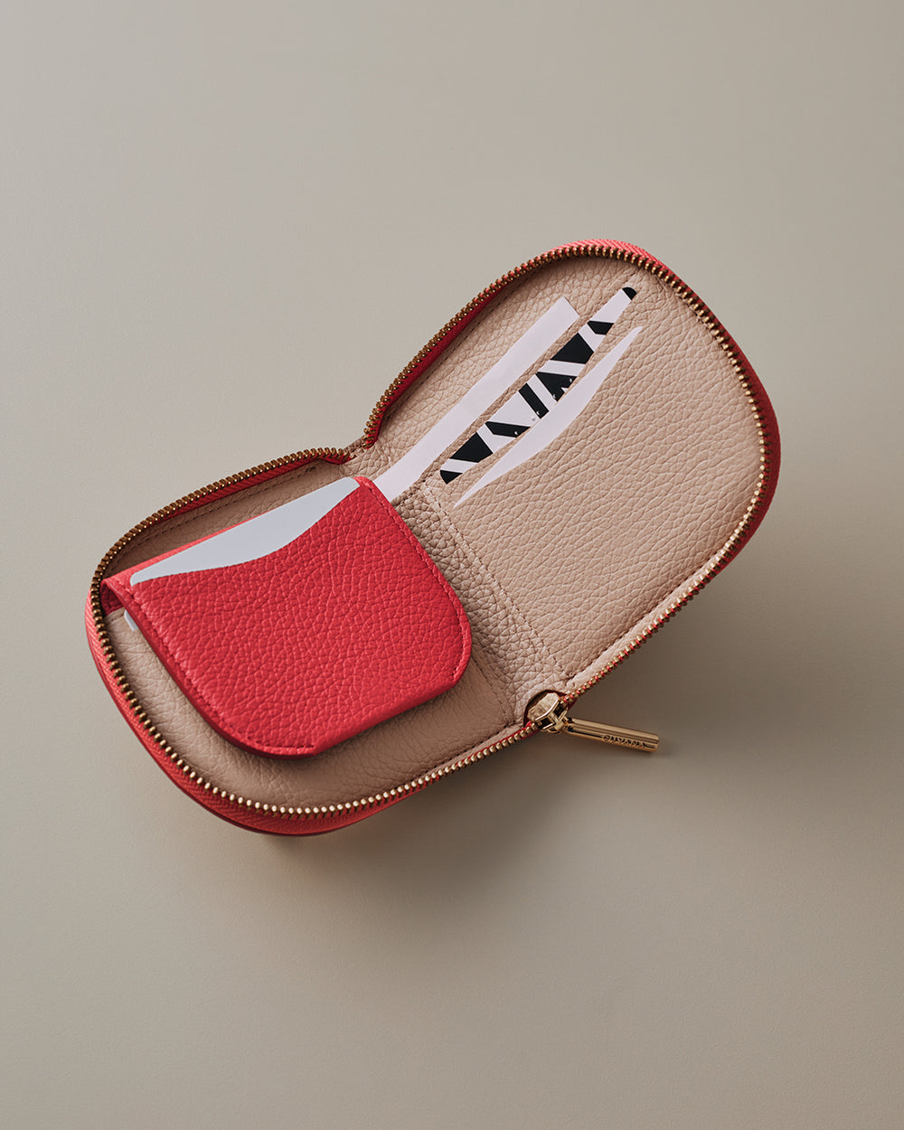 Duo Small Zip Wallet Small zippered wallet with card slots and a red pocket inside.