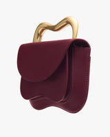 Handbag with unique gold handle design