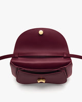 Open handbag with front pocket and clasp on display