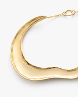 Curved metal necklace with a chain and clasp.