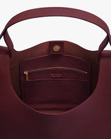 Open tote bag showing interior pocket with zipper and clasp.