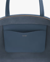 Open top view of a bag showing an inside pocket with a brand label.