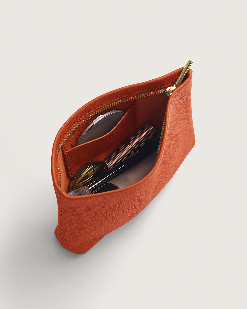 Mini Zipper Pouch Open pouch with zipper containing sunglasses and two small items inside.