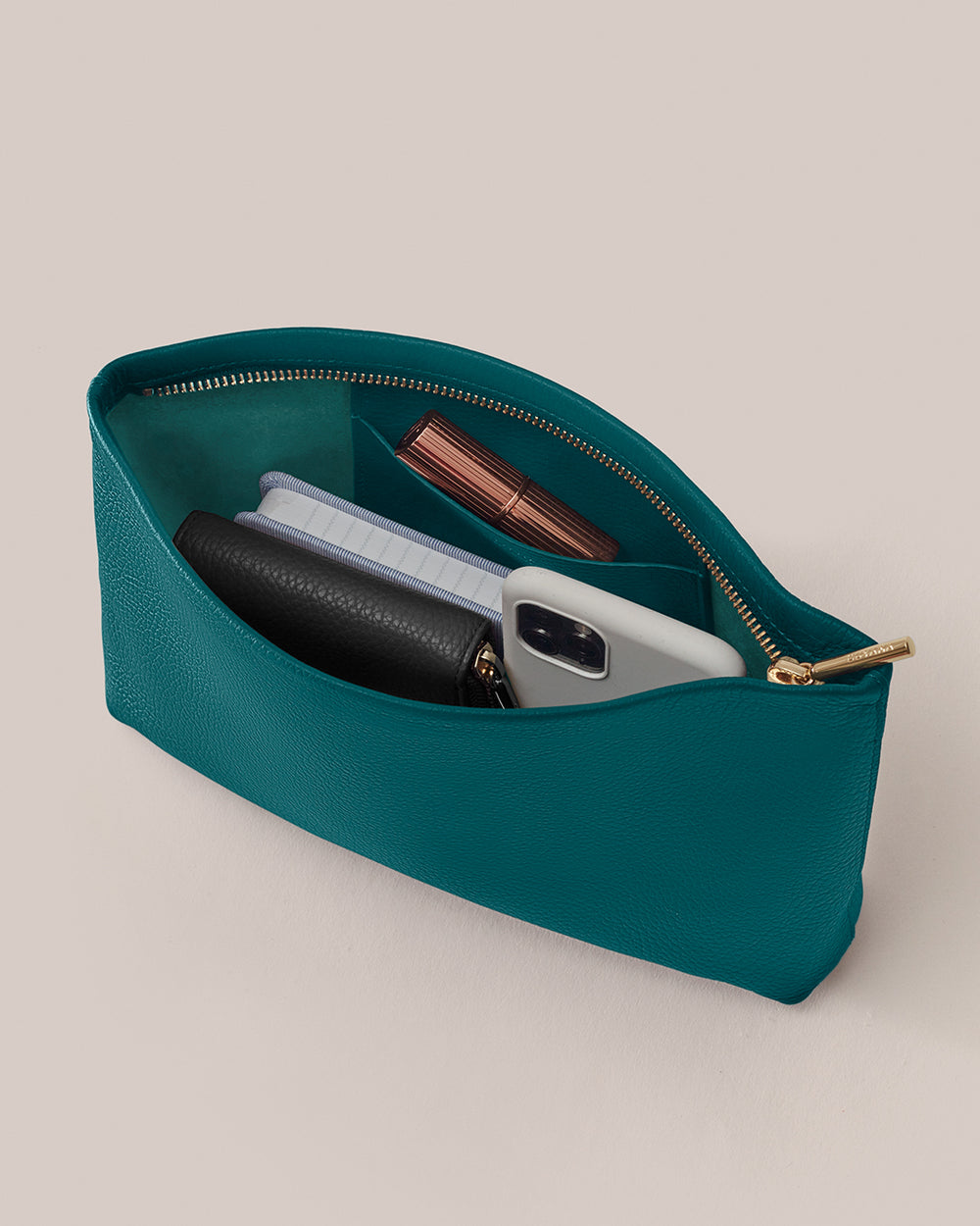 Small Zipper Pouch Open pouch with wallet, phone, notebook, and lipstick inside.