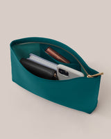 Open pouch with wallet, phone, notebook, and lipstick inside.