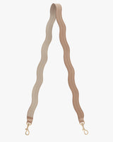 Wavy strap with buckles at both ends on a plain background