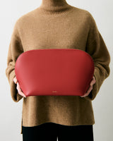 Person holding a large pouch