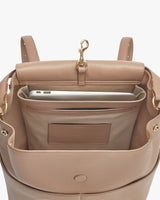 Open backpack showing inside pockets with a laptop and a strap hook.