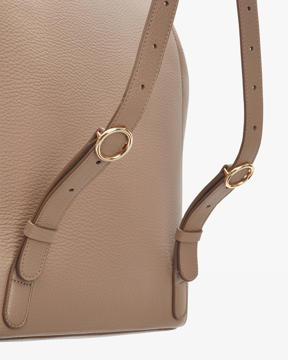 Close-up view of a bag with adjustable straps and metal rings.