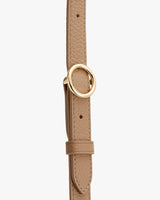 Leather strap with a circular metal buckle on it.