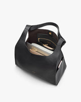 Open handbag with visible contents inside.