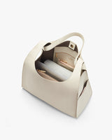 Open handbag showing inside compartments and contents.