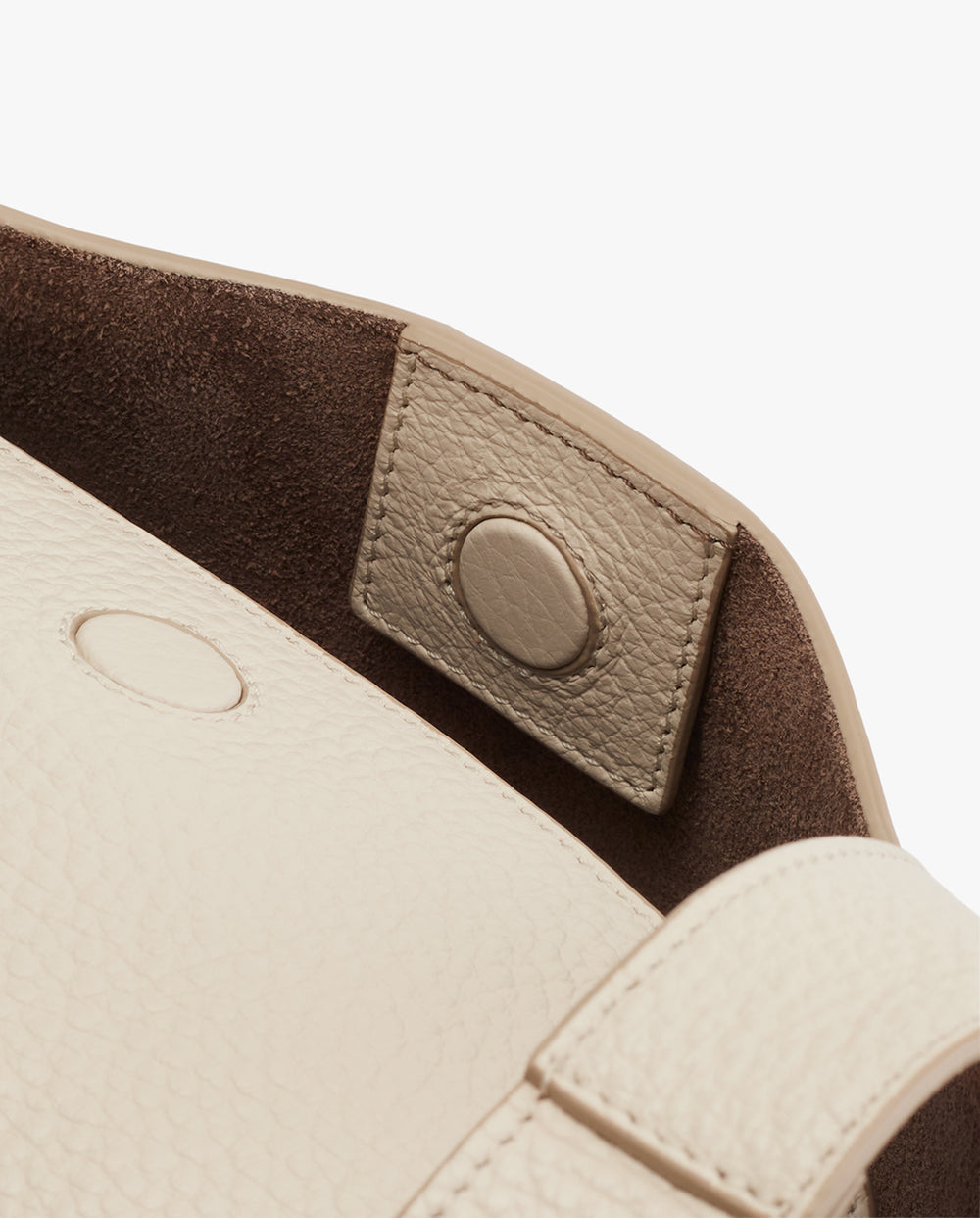 Close-up of a bag with a snap-button closure detail.