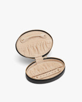Open jewelry box with interior pockets and zipper closure.