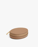Round zipper case on a plain background.