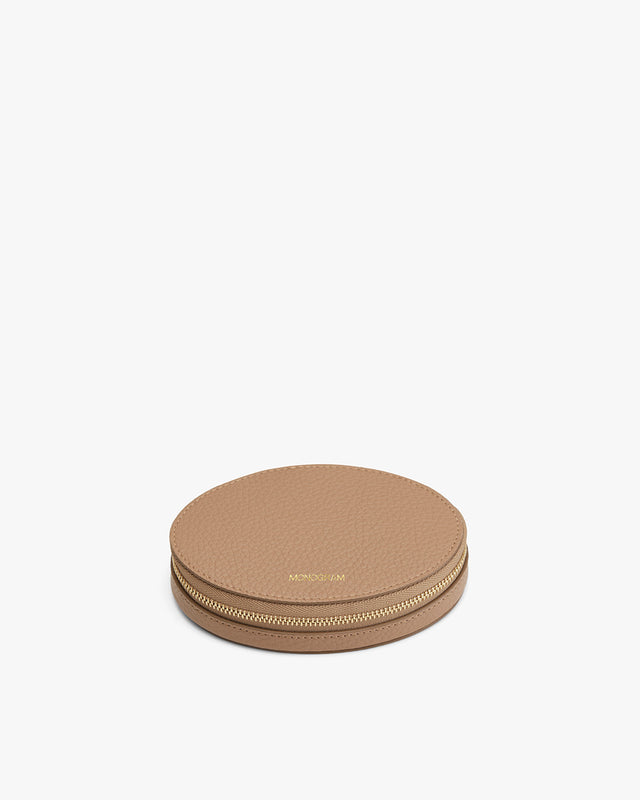 Round zippered case on a plain background.