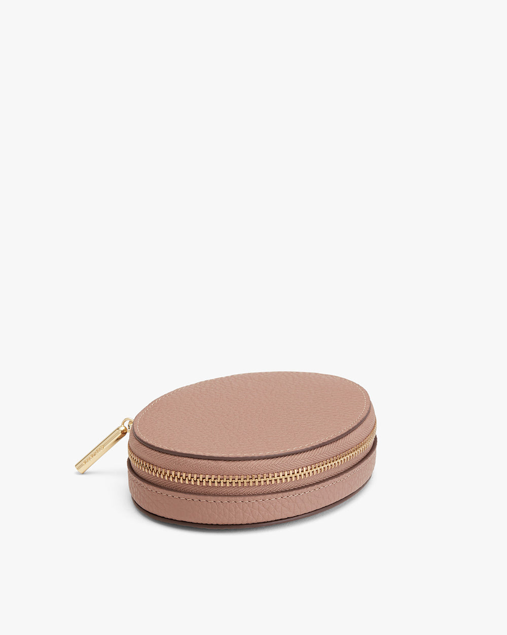 Round zipper case with pull tab on a plain background.