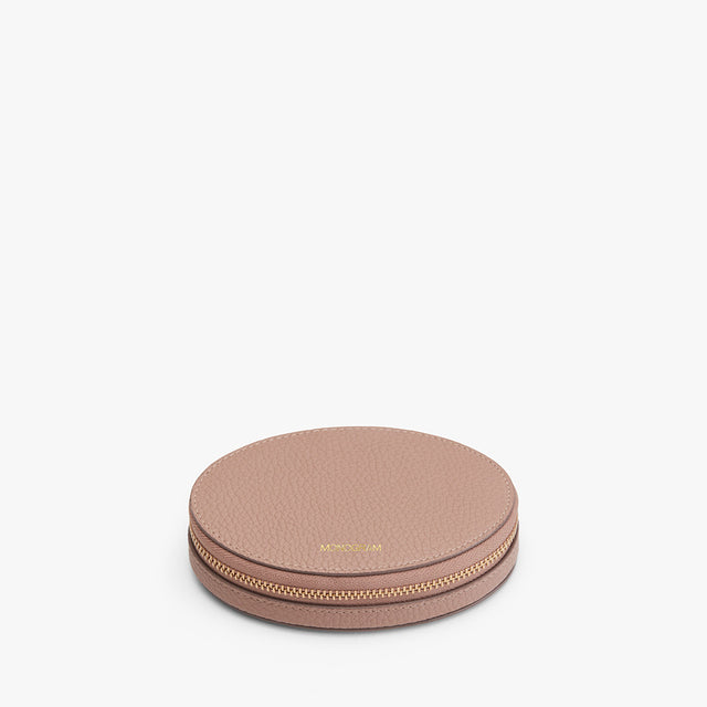 Round zippered case with brand name on top, centered on a plain background.