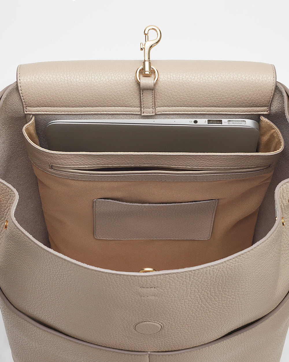 Open handbag with a laptop and smartphone inside.