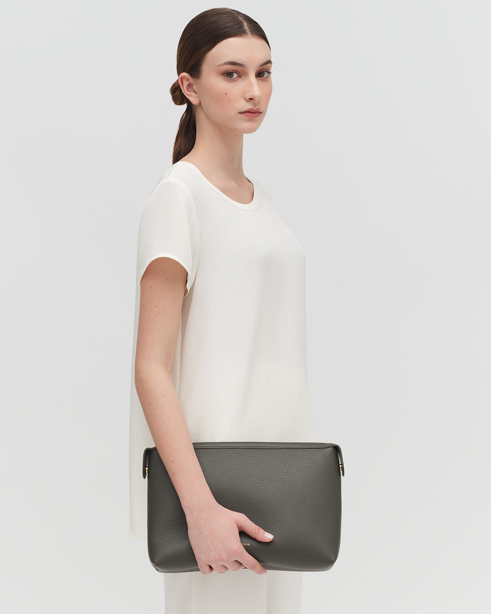 Woman standing with a handbag