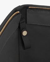 Open handbag with gold zipper and interior compartment.