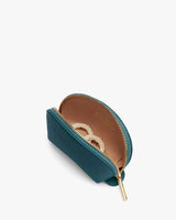 Half-open small purse with a zipper and jewelry inside.