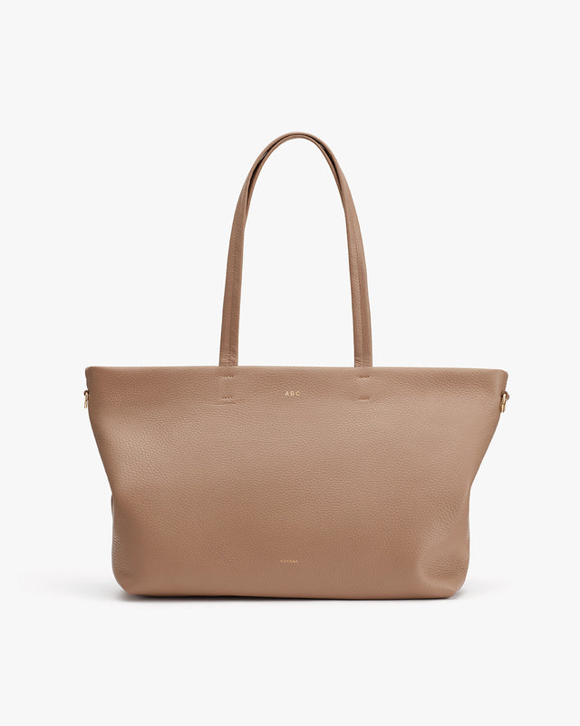 Leather tote bag with two handles and a zipper on top