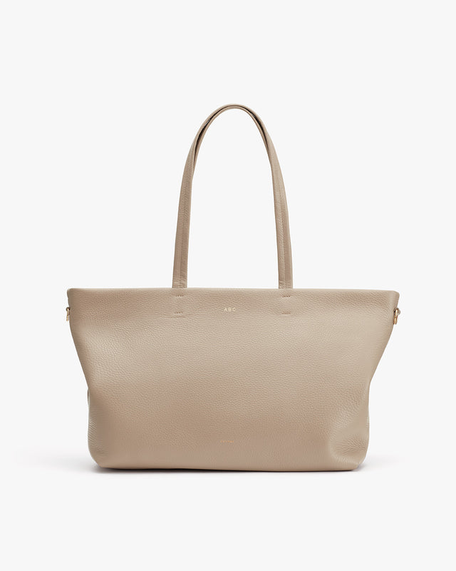 Tote bag with two handles, standing upright against a plain background.