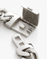 Close-up of an open metal clasp attached to a chain.