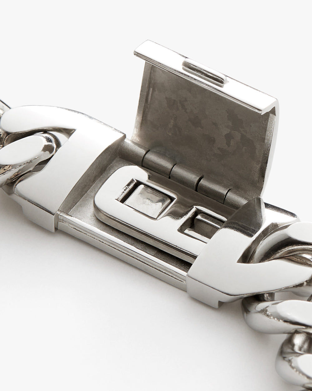 Close-up of a metal belt buckle on a white background.