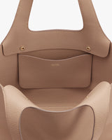 Close-up view of an open handbag with a visible inner pocket.