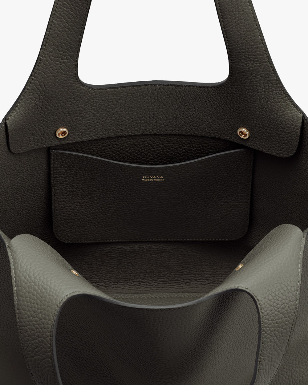 System Tote 13-inch Close-up of an open handbag with a visible brand name on the inner pocket.