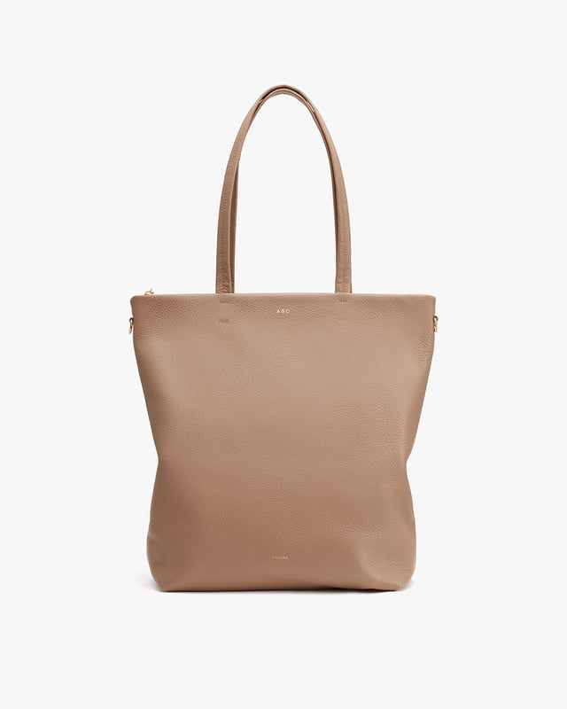 Simple leather tote bag with handles and a zipper.