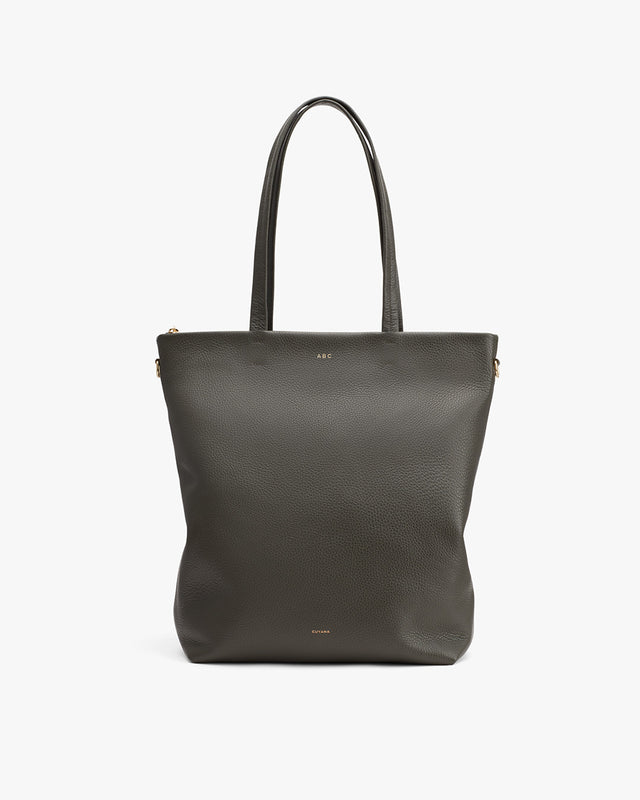 Vertical tote bag with two handles and a subtle logo on the bottom front.