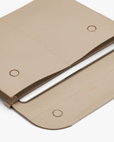 Laptop sleeve partially open with a laptop inside.
