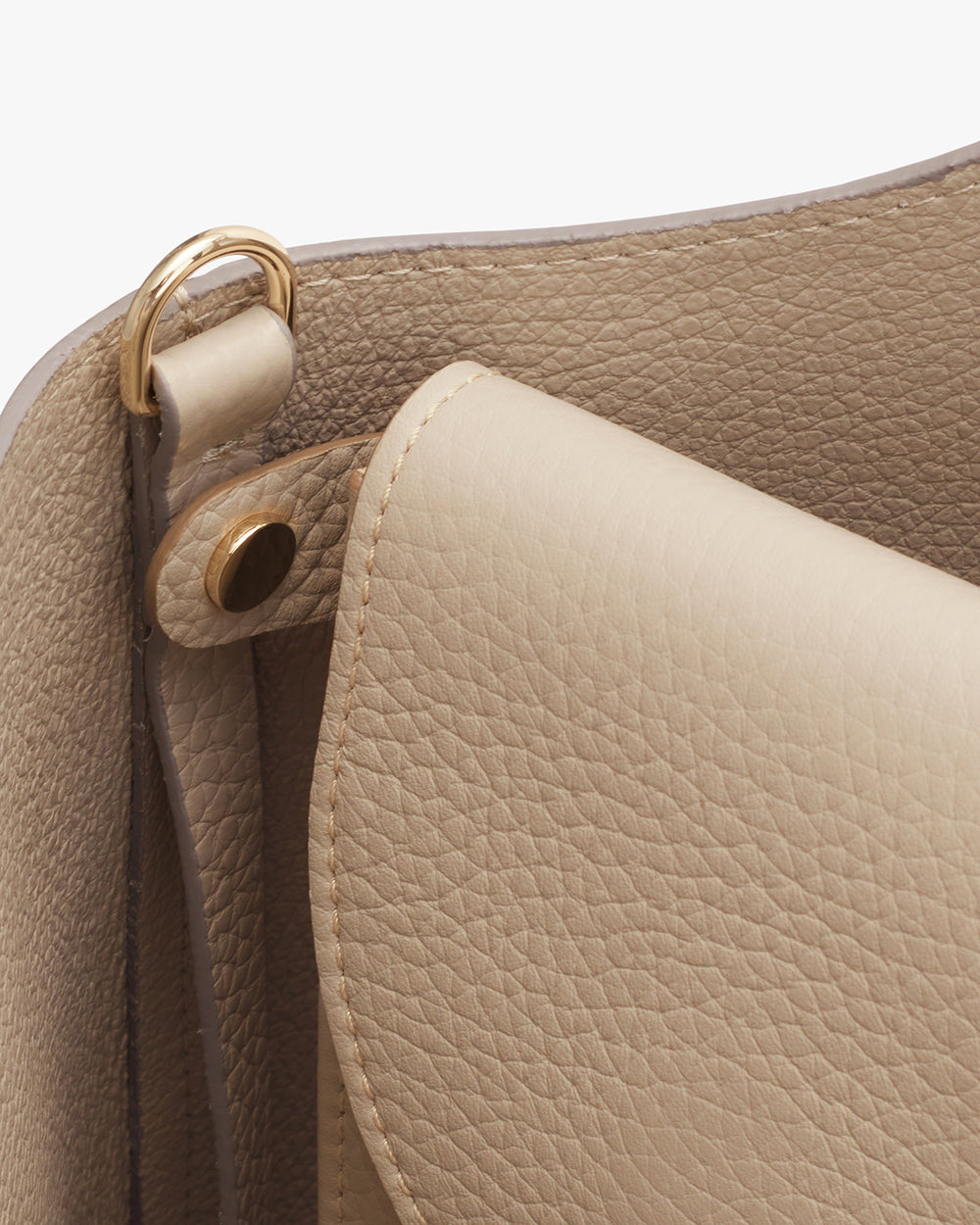 Tech Carryall 16-inch Close-up of a handbag with a focus on its handle attachment and stitching.