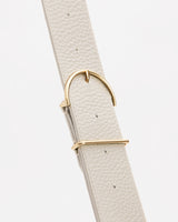 Close-up of a textured belt with a metallic buckle.