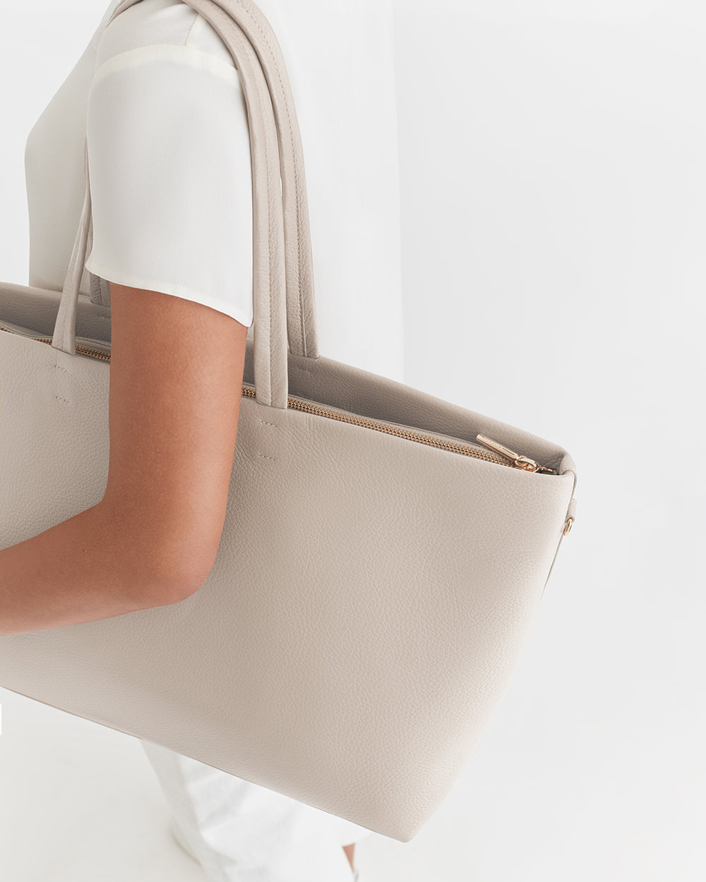 Classic Easy Zipper Tote Person holding a large handbag on their shoulder.