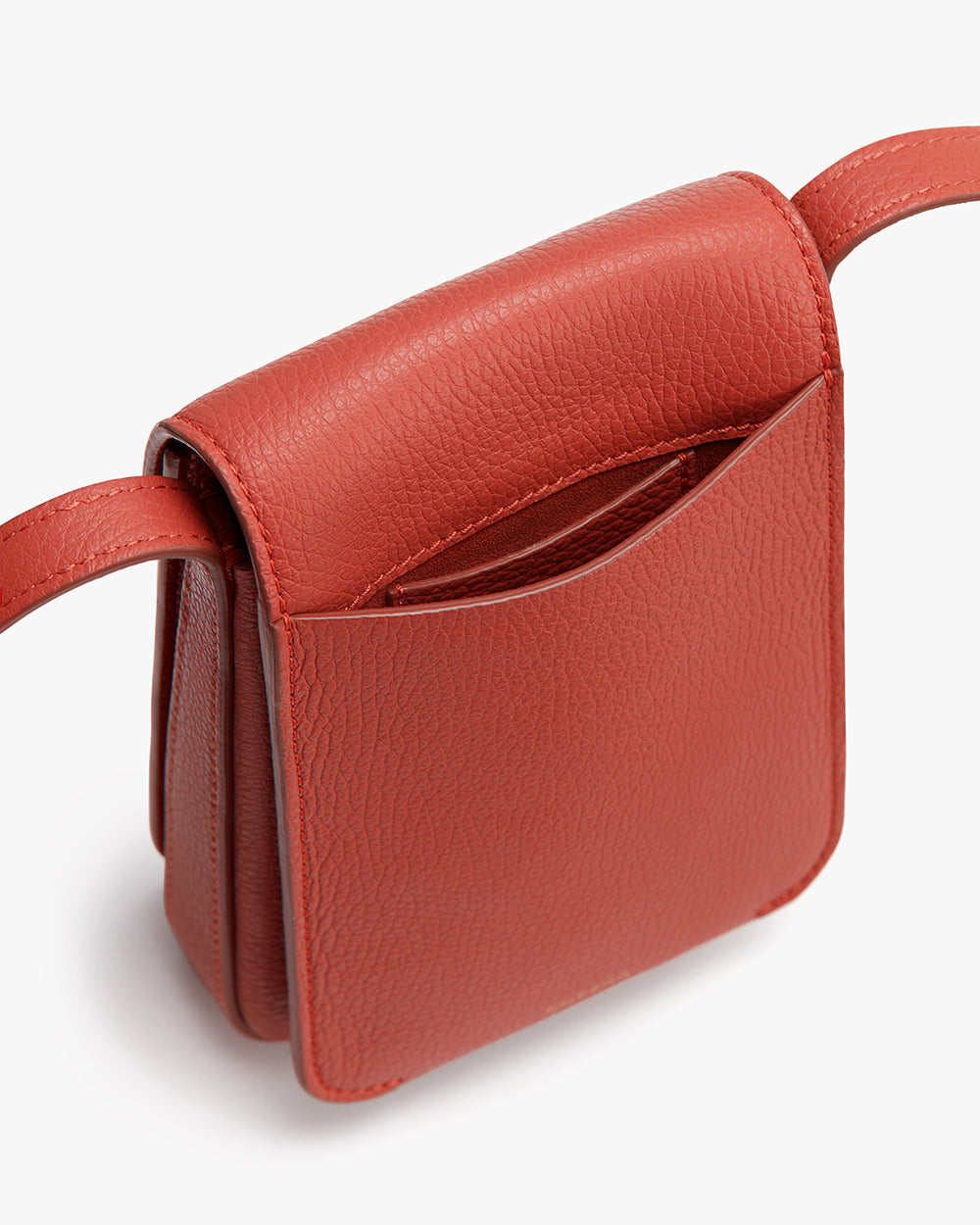 Small shoulder bag with flap closure and adjustable strap.