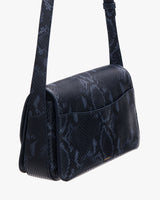 Small shoulder bag with a textured pattern and an adjustable strap.