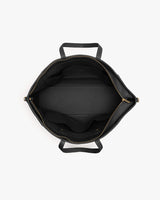 Top view of an open travel bag showing internal compartments and handles.