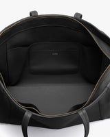 Open handbag showing interior design with zipper closure and internal pocket.